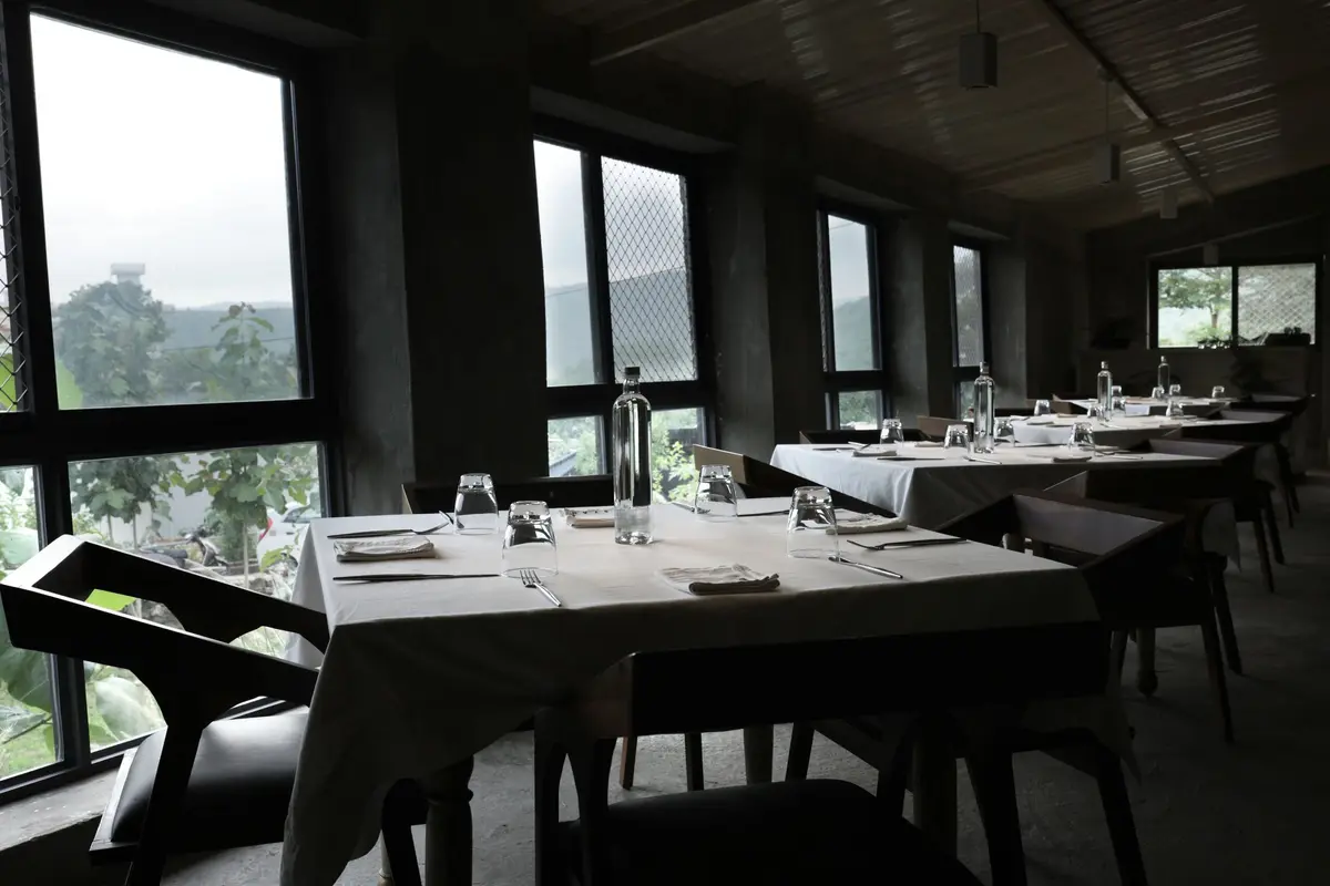 Syah's dining room with tall windows looking out over the farm