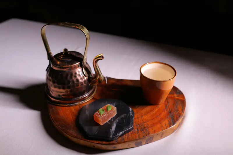 Asafoetida mint tea in a copper kettle with orange jelly