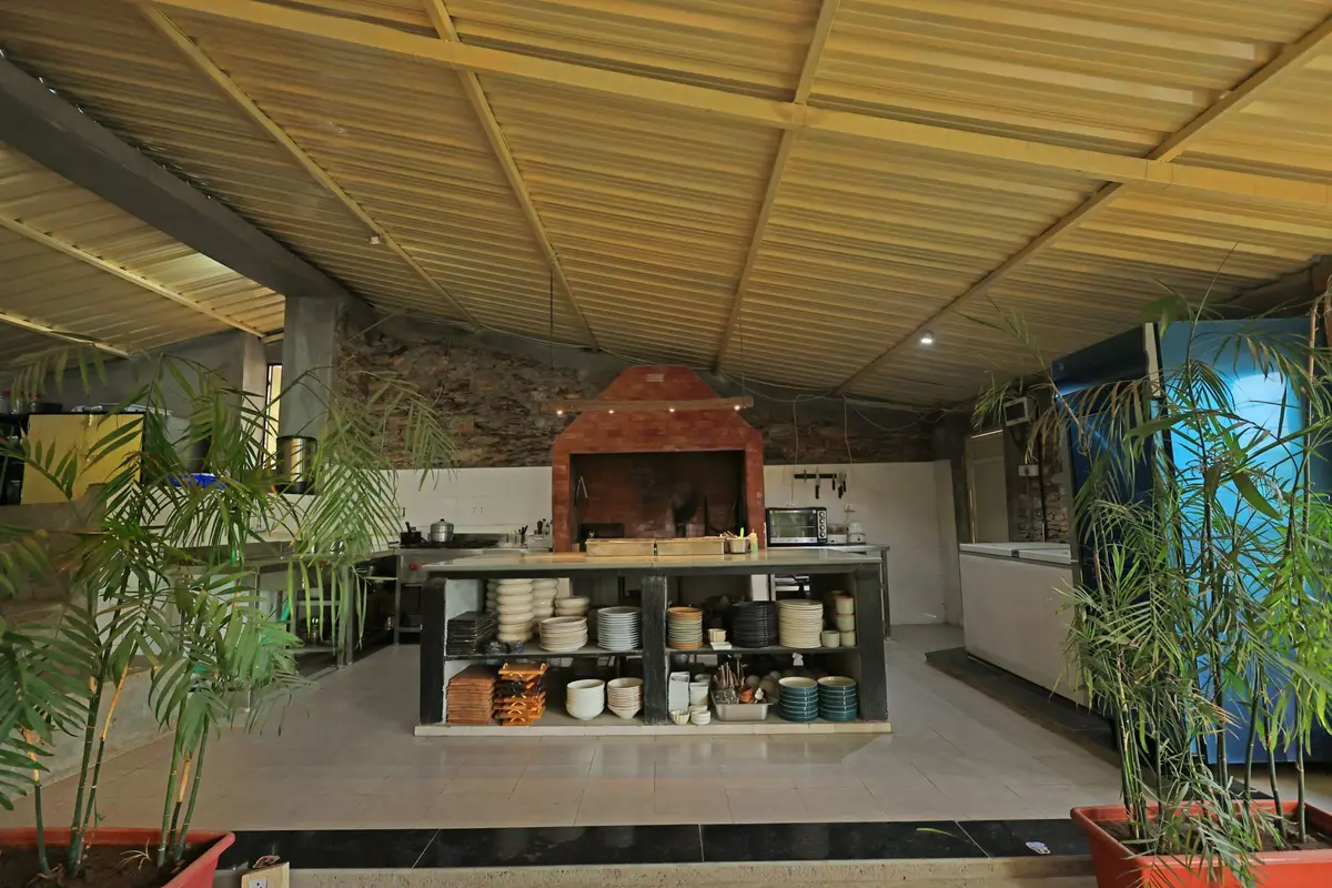 The open kitchen with a wood-fired oven and ceramic plates