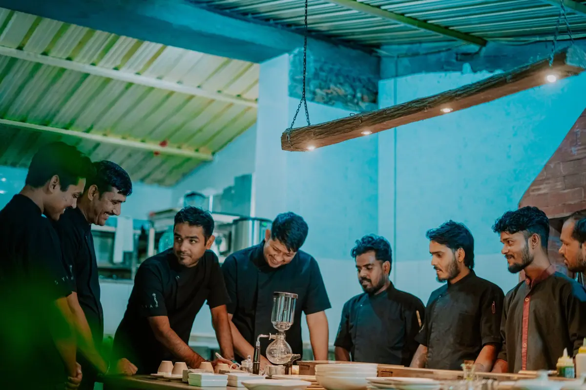 The Syah kitchen team in black aprons around the pass